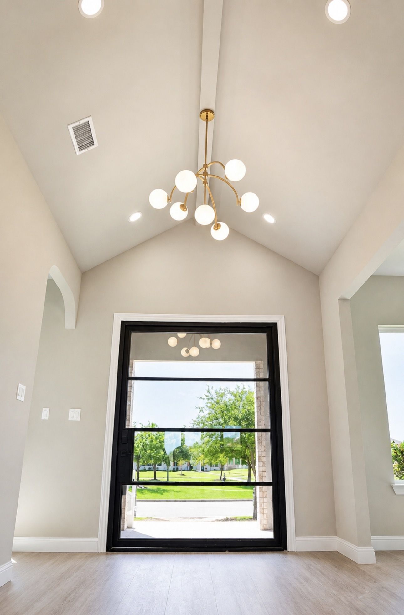 Foyer with pivot glass door